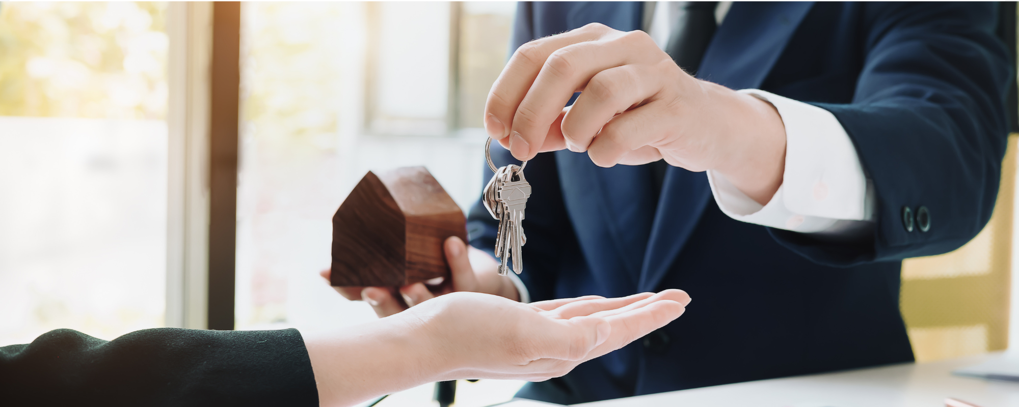 how to hire a real estate attorney in Florida, Real estate attorney handing the keys to a new homeowner